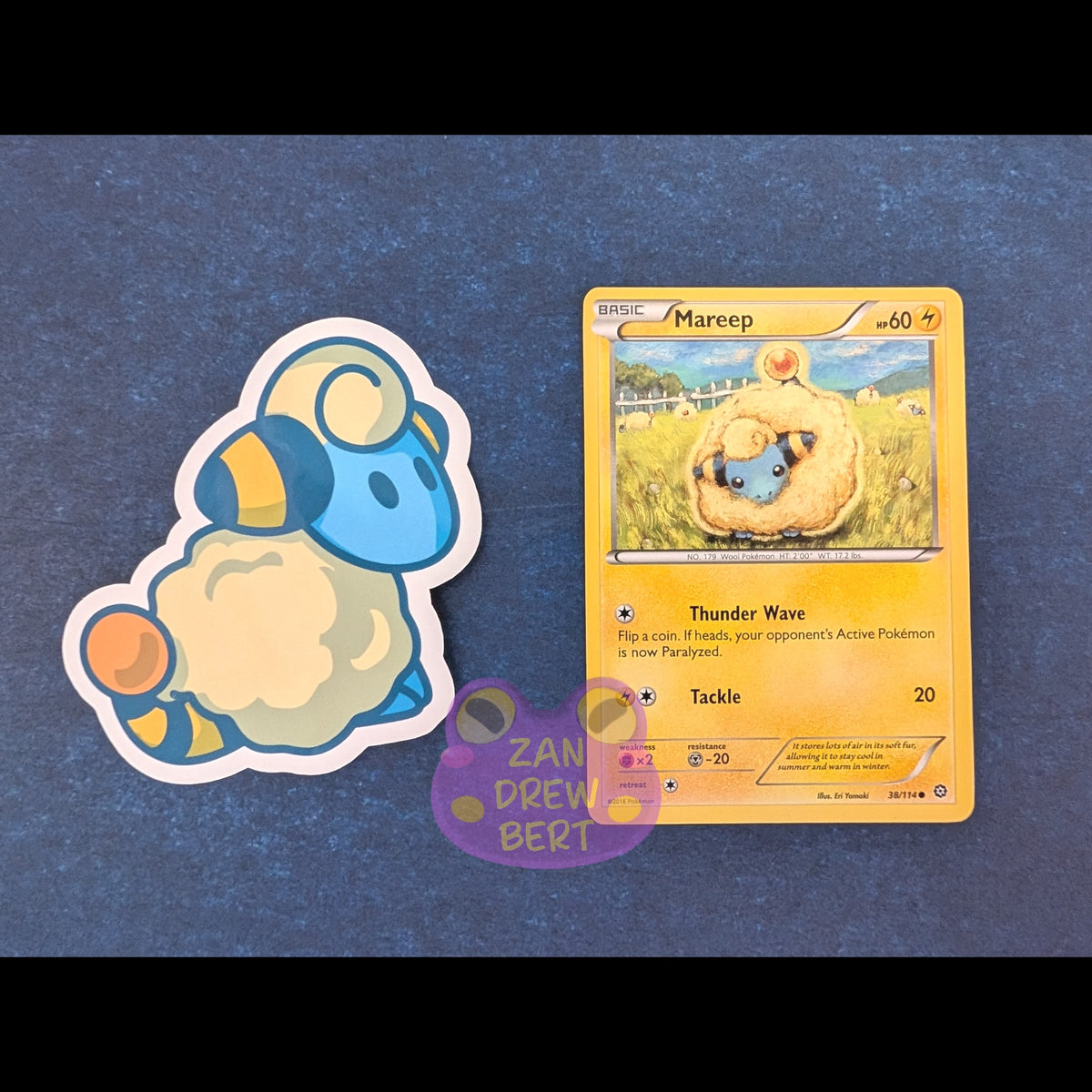 Mareep sticker next to a mareep pokemon card to show the size of the sticker.